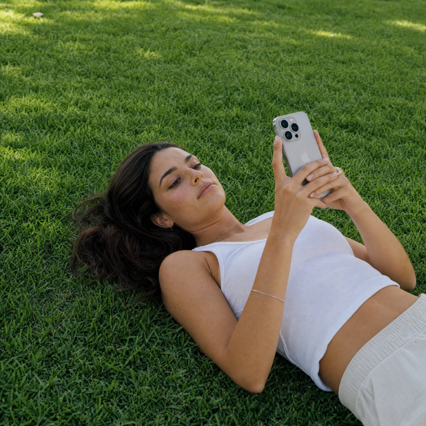 A young adult using a phone outdoors