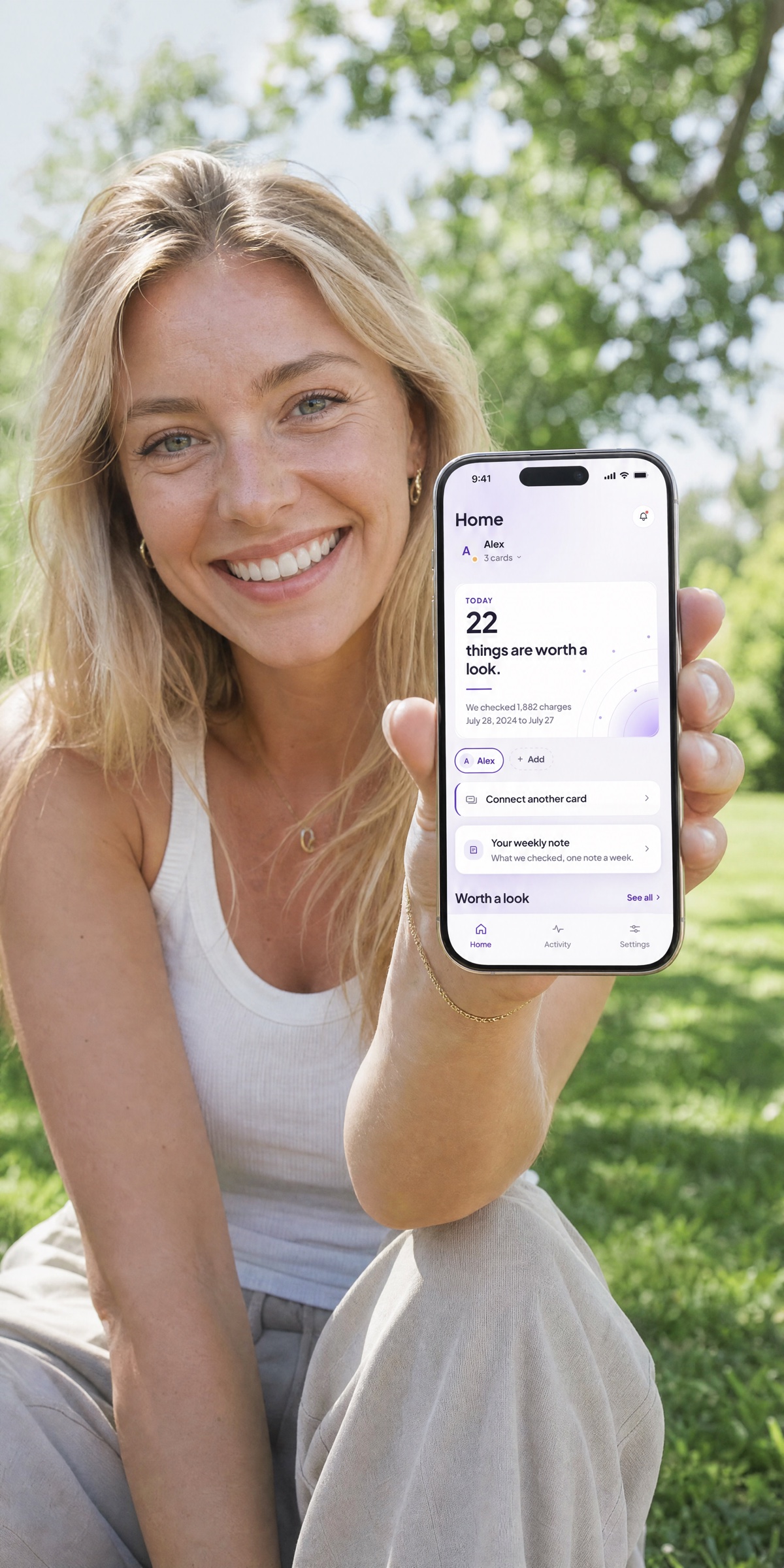 A parent holding a phone showing Guardian outdoors